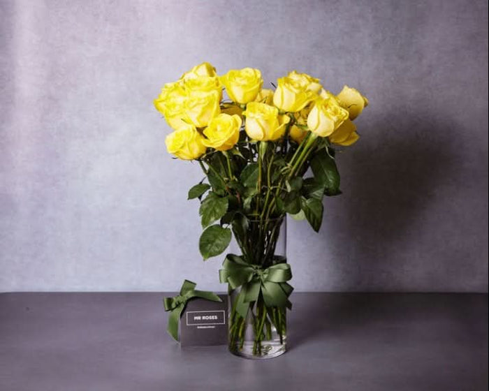 long stemmed yellow roses in a vase